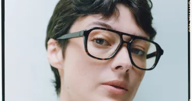 Frau mit kurzen braunen Haaren und Acetatbrille