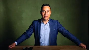 Mann in Hemd und Jacket schaut in die Kamera