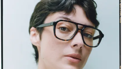 Frau mit kurzen braunen Haaren und Acetatbrille