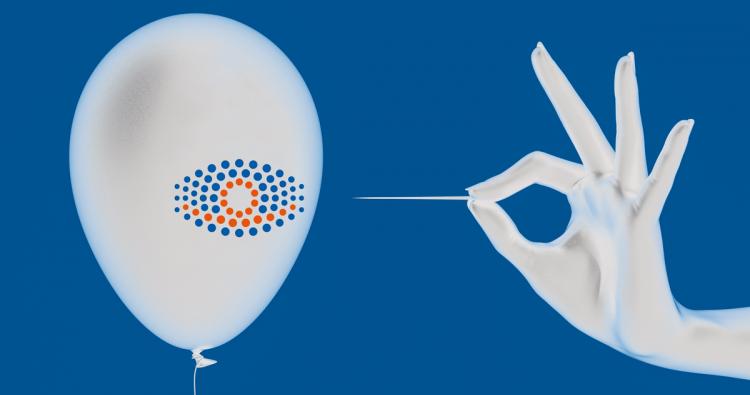 Lufballon mit GrandVision-Logo und Hand mit Nadel
